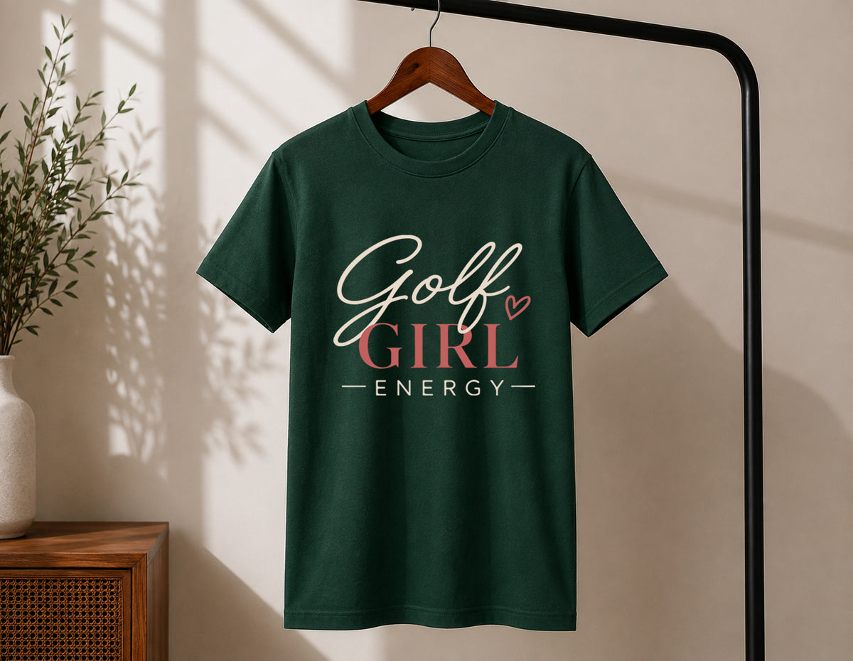 Golf Girl Energy women's golf statement tee displayed on wooden hanger